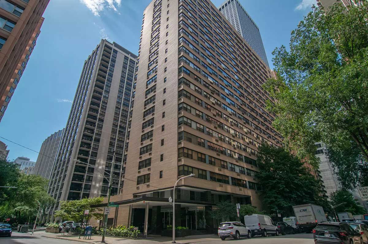 The front view of 850 North Dewitt Place Unit 4H in Chicago's Streeterville neighborhood. Listed for sale by The DelGreco Team from Coldwell Banker Realty's Lincoln Park Office. The building is a red brick mid-rise high rise.